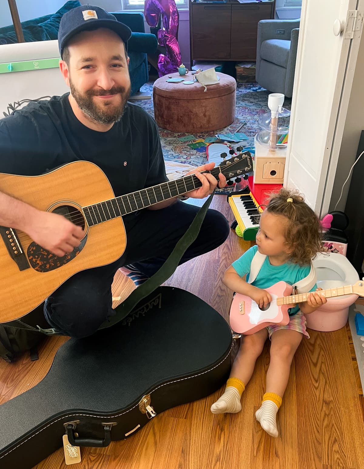 Dan teaching guitar to a young student
